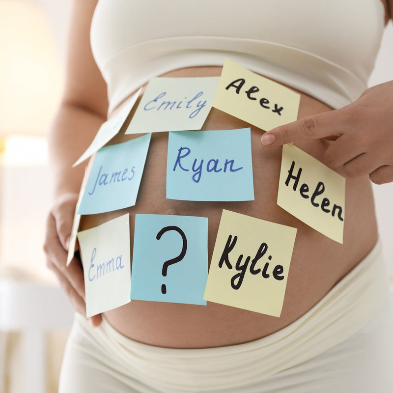 Pregnant belly covered with post-it notes featuring different baby names