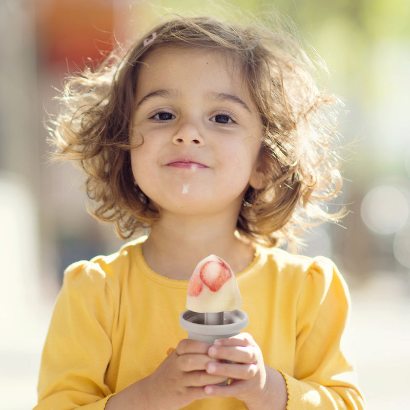 Small child eating a homemade ice cream from the Haakaa Freeze-n-Sip Ice Cream Mould