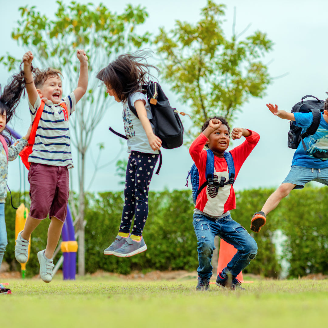 Children jumping in the air to celebrate the end of term